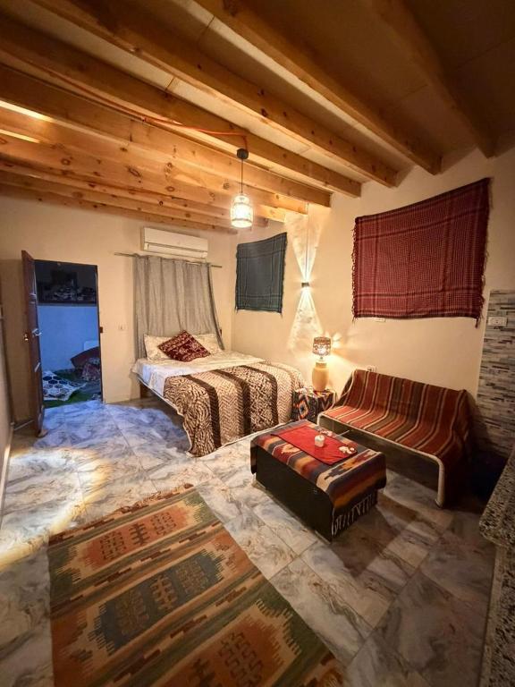 a living room with two beds and a couch at Omar Cozy in Dahab