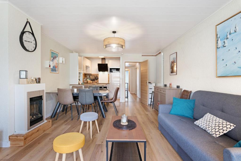a living room and kitchen with a couch and a table at Les Gemeaux 2 - 6 personnes in Villard-de-Lans