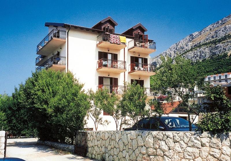 a building with a car parked in front of it at Penzion Sovulj SKALLA CZ in Omiš