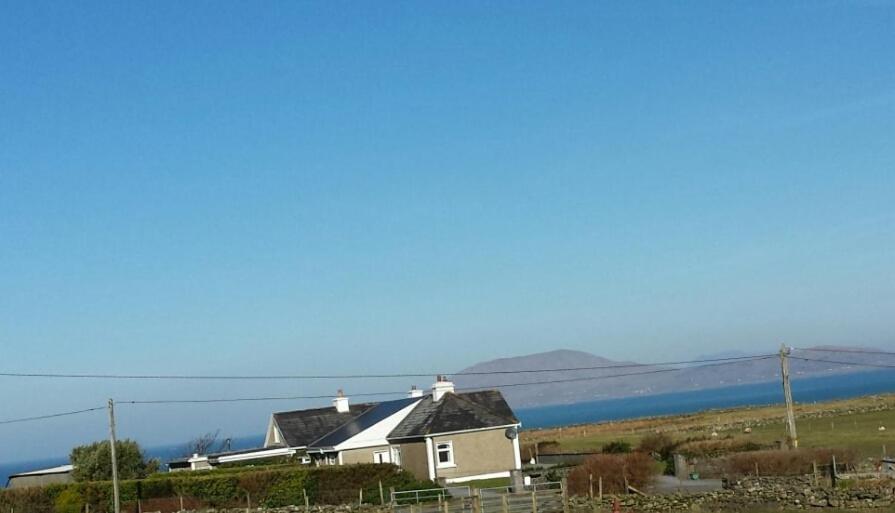 a house on a hill next to a body of water at Kates coastal cottage in Aillemore