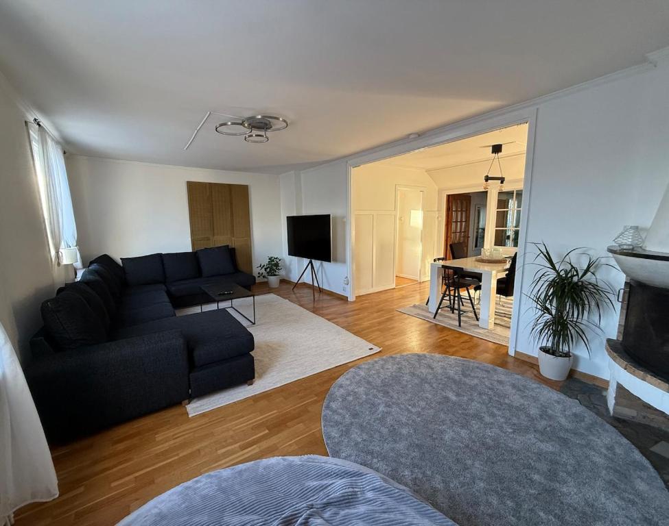 a living room with a couch and a table at Spacious flat 15 min to the beach in Falkenberg