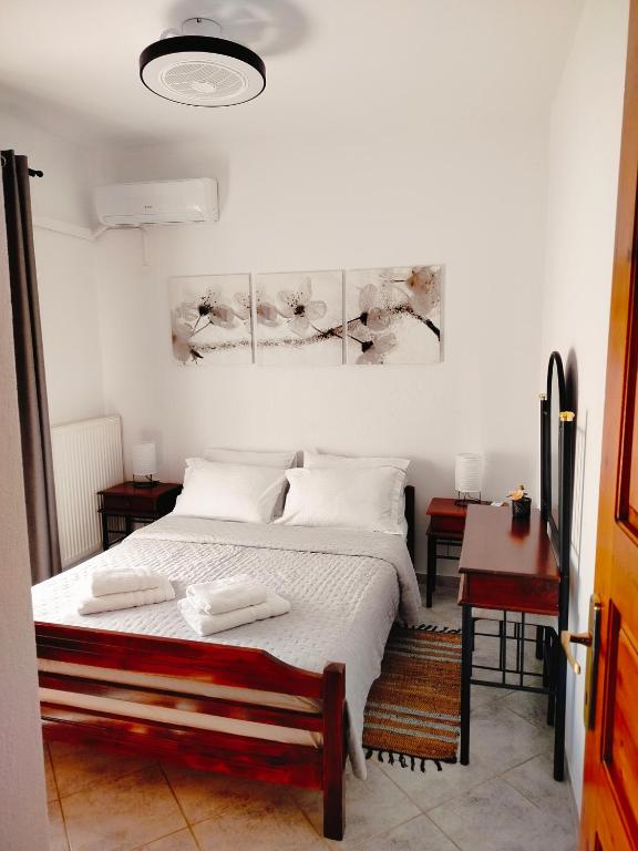 a bedroom with a bed with two towels on it at Polynikis Apartment in Nikiti