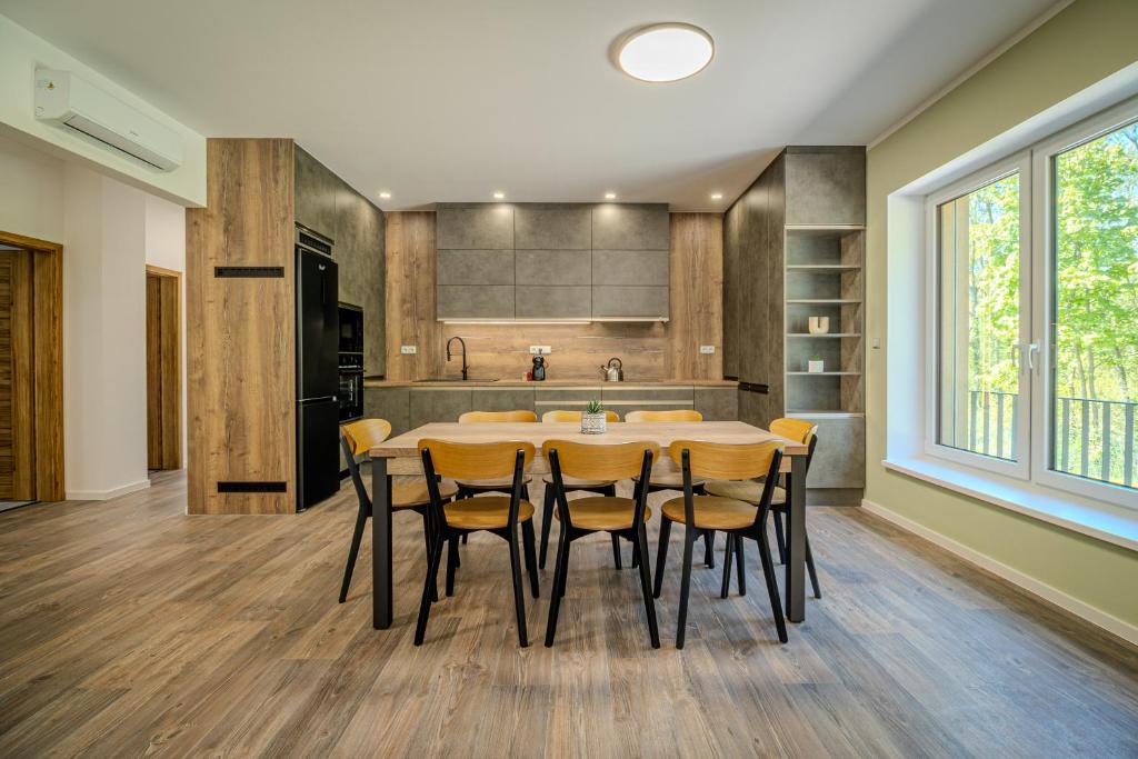 a kitchen with a large dining room table and chairs at Ubytování U Lesíka in Znojmo