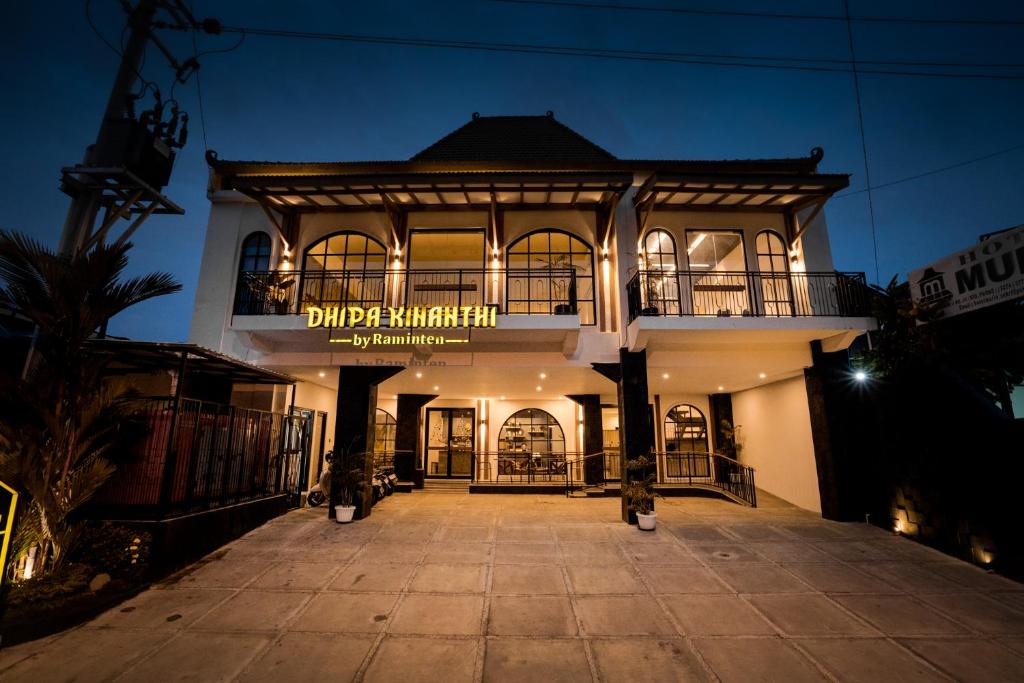 a large building with a sign on it at night at Dhipa Kinanthi Prawirotaman by Raminten in Timuran