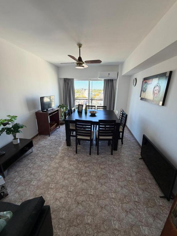 a living room with a dining room table and chairs at Los Altos Pergamino in Pergamino