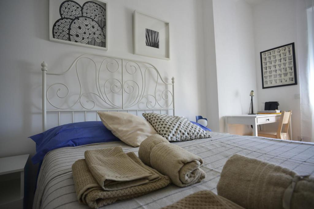 a bedroom with a white bed with towels on it at Sunset Suite in Laveno-Mombello