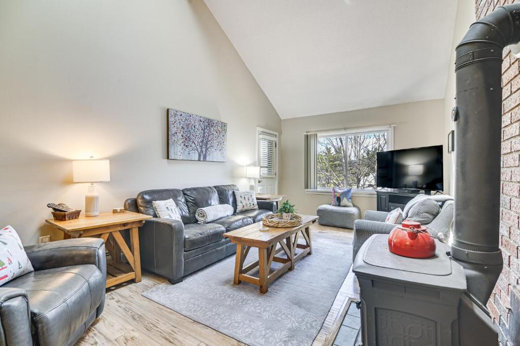 a living room with a couch and a fireplace at Cozy Bartlett Condo: 1 Mi to Attitash Ski Resort! in Bartlett