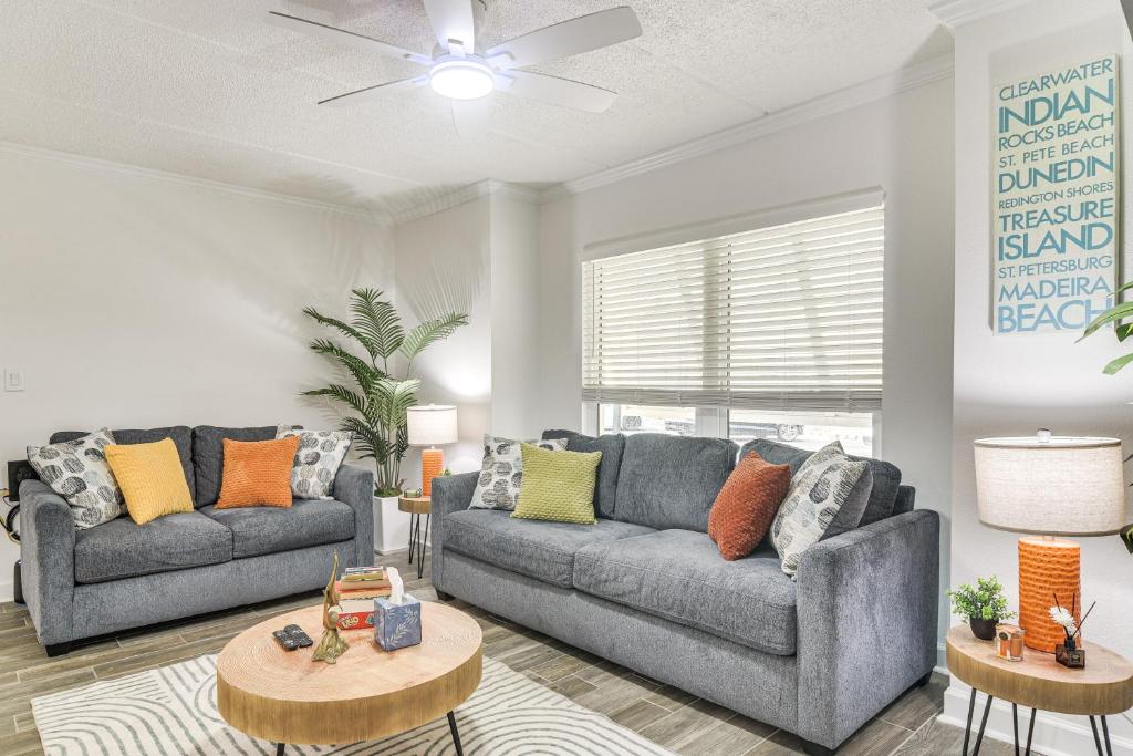 a living room with two couches and a table at < 2 Mi to Coast: St Pete Beach Gem w/ Pool Access in St. Pete Beach