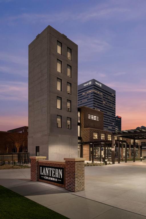 a tall building with a sign in front of it at The Lantern Hotel Columbia in Columbia