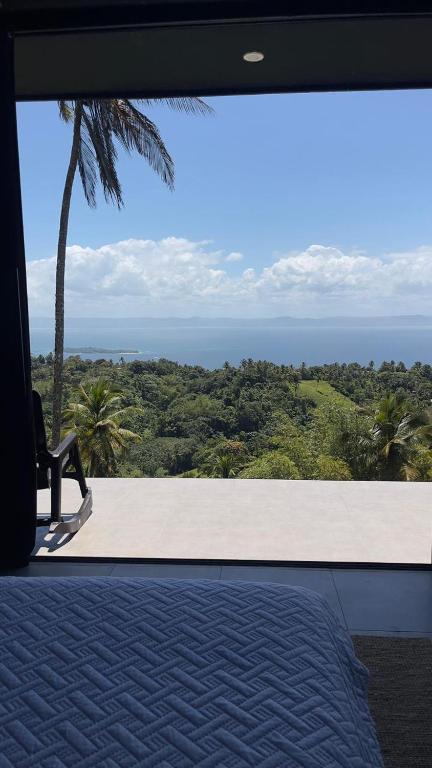 a person sitting on a bench looking out at the ocean at AGV II Cayo View in Monte Rojo