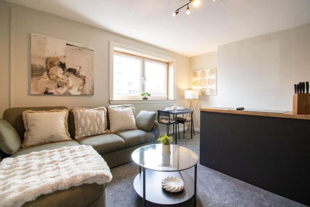 a living room with a couch and a table at Modern 2-Bed Apartment, Greenock in Greenock