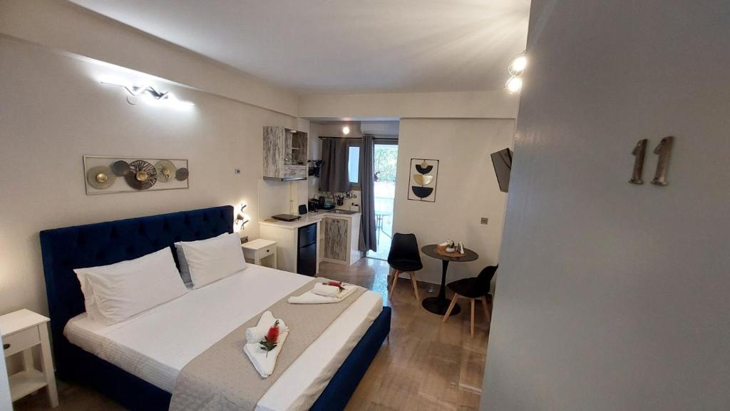 a small bedroom with a bed and a kitchen at NESTOR LUXURY Studios in Vathi