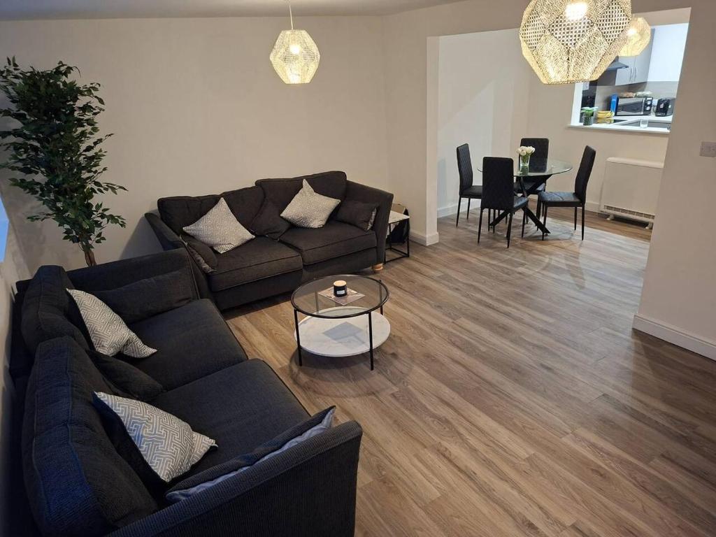 a living room with a couch and a table at Central 3BR home with Parking in Aberdeen