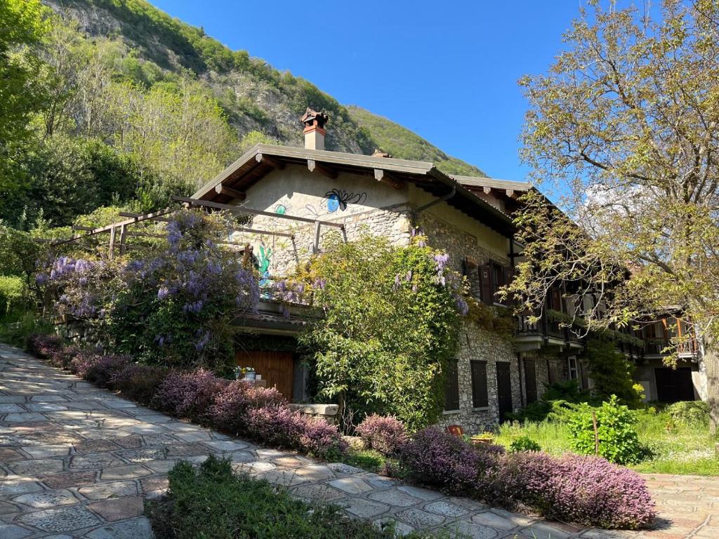 a house with a dog on the roof of it at Cascina Silene in Castelmarte