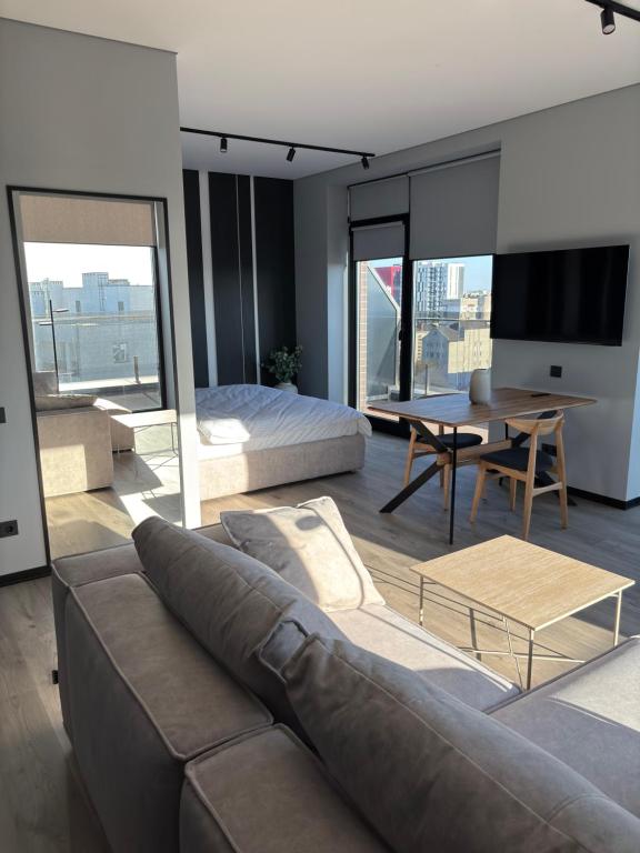 a living room with a couch and a table at Bavaro apartments 4 in Ivano-Frankivsk
