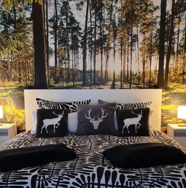 a bedroom with a bed with two deer pillows at Am Sommerrain in Elzach