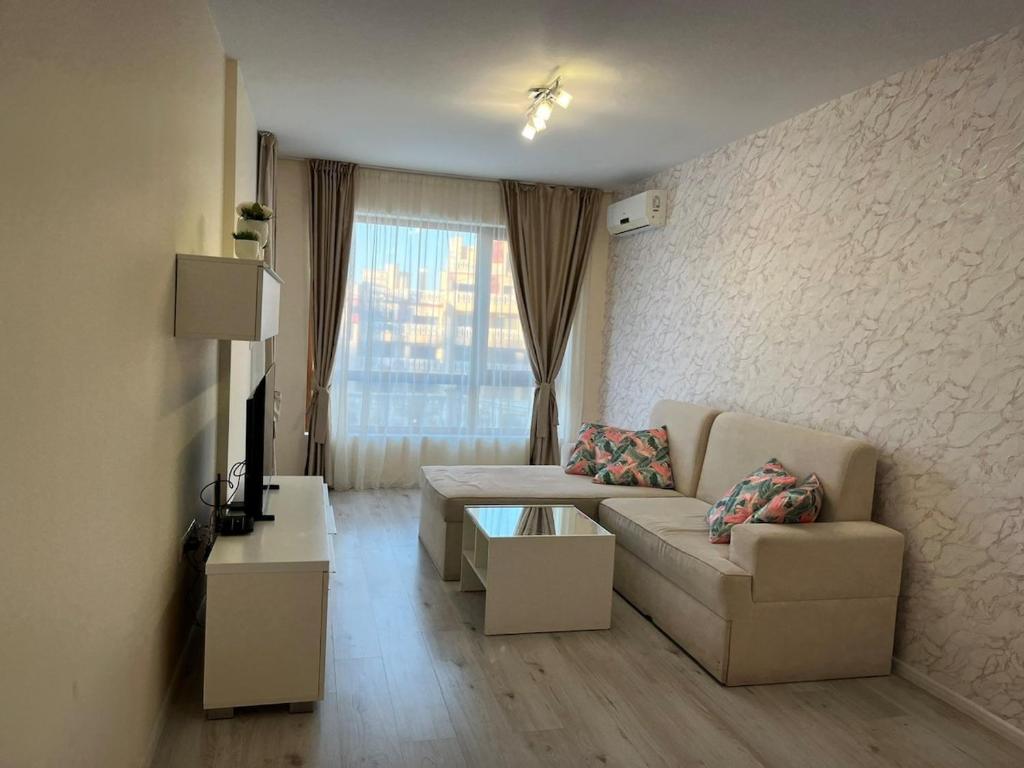a living room with a couch and a table at Joy Escape Varna in Varna City