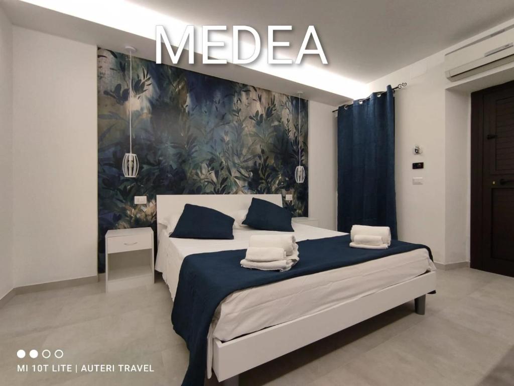 a bedroom with a bed with a mega sign above it at Tropea Travel's House in Tropea