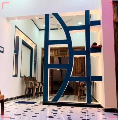 a room with a large blue door in a room at Dream Mahal in Kattankudi