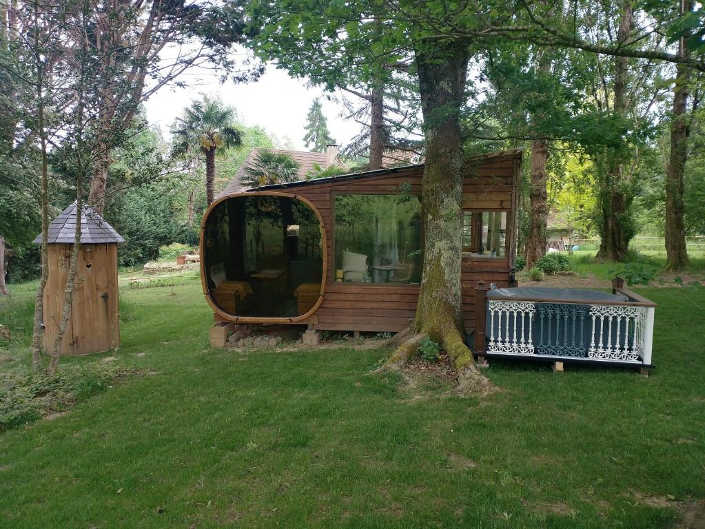 a small house in a yard with a tree at Le chalet de Montestrucq in Montestrucq