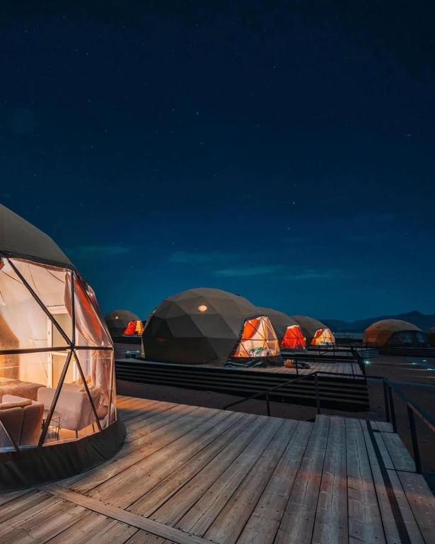 three domes on the deck of a boat at night at Wadi Rum Story Camp in Wadi Rum