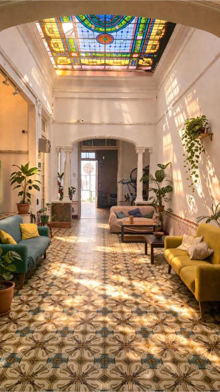 a large living room with a stained glass ceiling at Hostel Bohemian in Montevideo