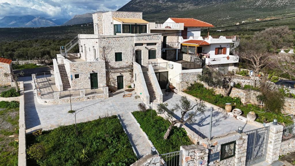 an aerial view of a house with mountains in the background at Mani Tigani View Studio in Kafióna