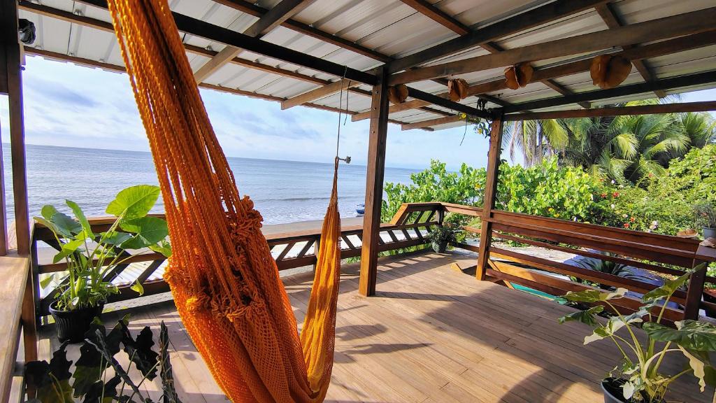a porch with a hammock overlooking the ocean at cabaña malambo in Termales - agua caliente - nuqui