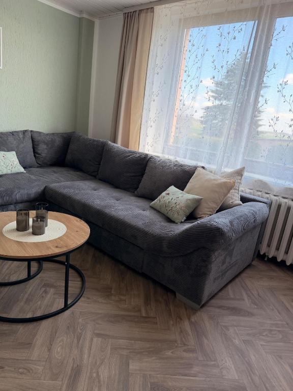 a living room with a couch and a table at Ferienwohnung Börnecker Landruhe in Börnecke