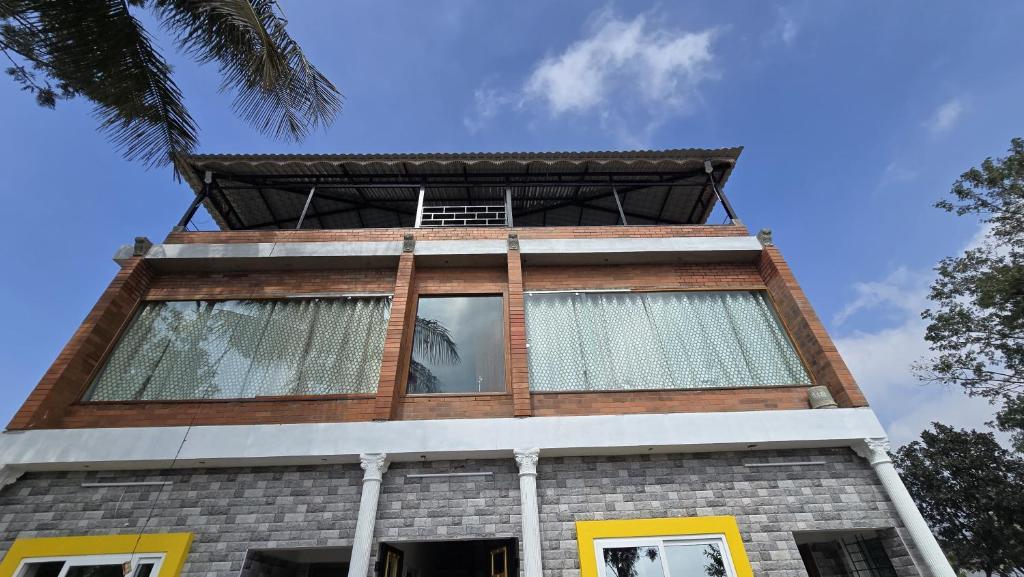 a tall building with windows on top of it at Sunrise Inn in Yelagiri