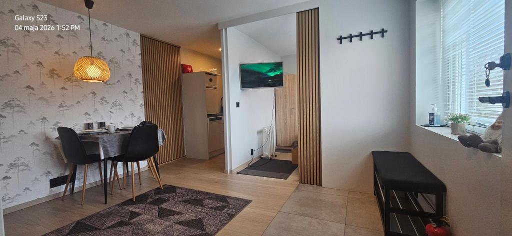 a small dining room with a table and chairs at Ramfjord Apartment 2 in Tromsø