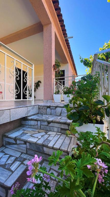 a house with some plants and flowers in front of it at eljos house permet in Përmet