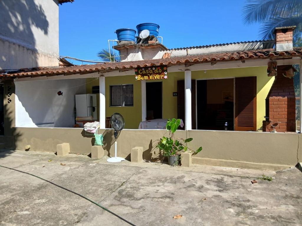 a house with a sign on top of it at Casa do Bem Viver in Trindade