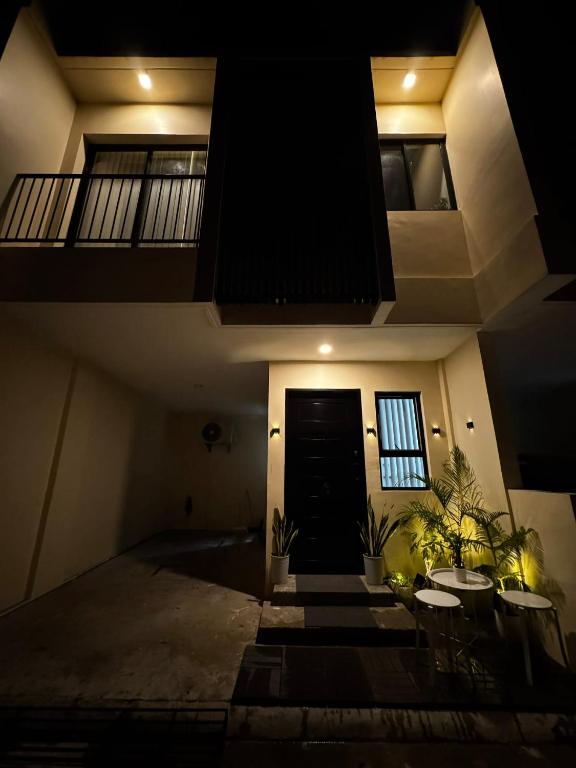 a room with a black door and some plants at Entire House with Parking, Full Kitchen and Near SRP, Seaside and Nustar in Talisay