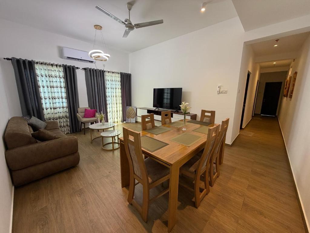 a dining room and living room with a table and chairs at Colombo lotus tower view Apartment in Colombo