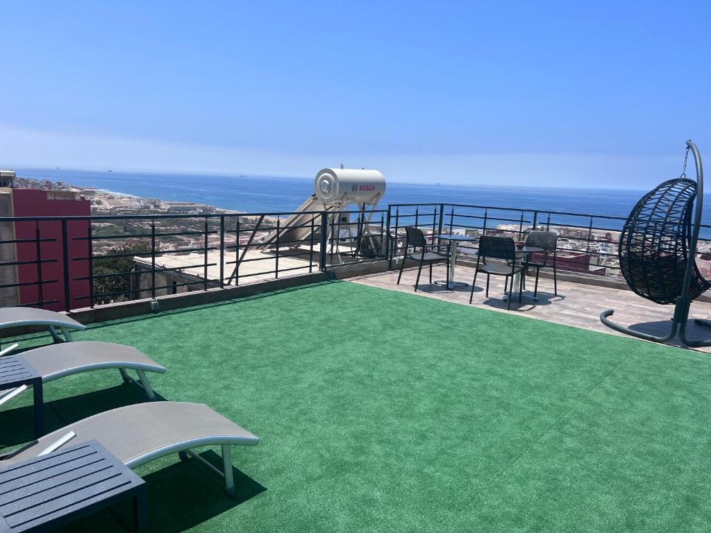 a balcony with chairs and a view of the ocean at Appartement 3 vue sur mer in Tamraght Ou Fella