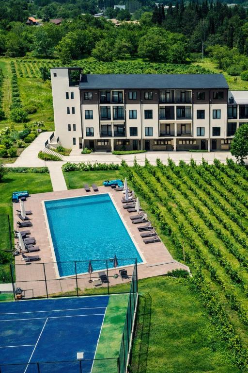 an aerial view of a building with a pool and a tennis court at Sunset Telavi in Telavi