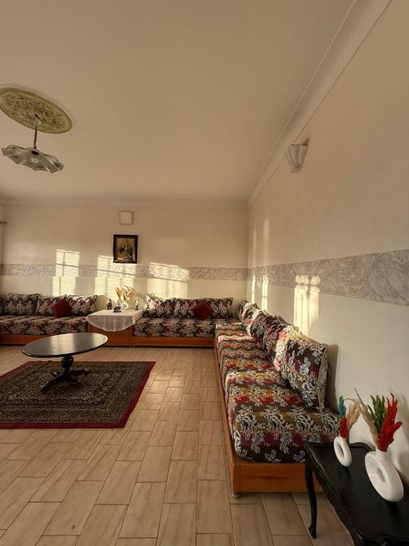 a large living room with a couch and a table at Beachfront house in El Jadida