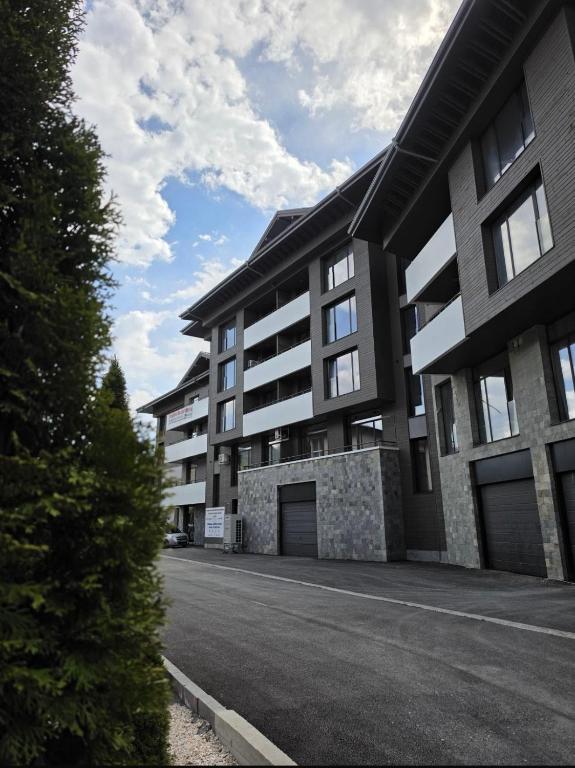 a building with a parking lot in front of it at Oblivion 1 in Velingrad