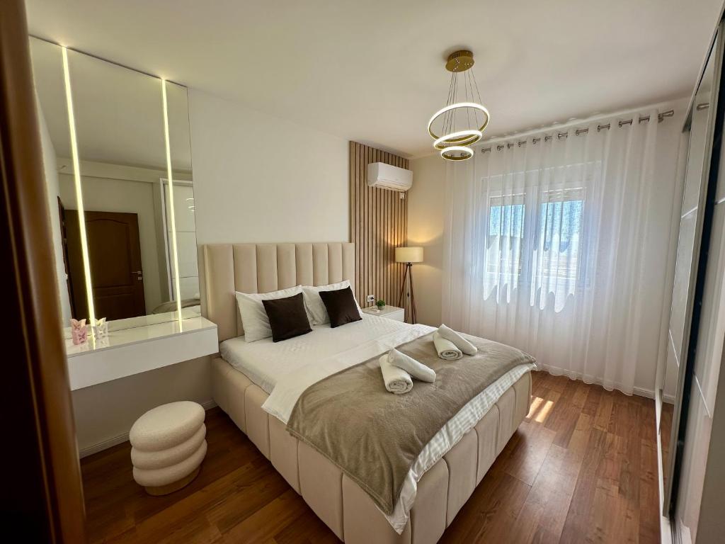 a bedroom with a large bed with a large mirror at White Hill in Ulcinj
