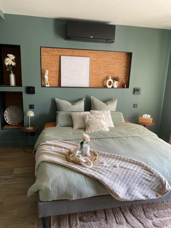 a bedroom with a large bed with a large headboard at La chambre du moulin dort in Chénelette