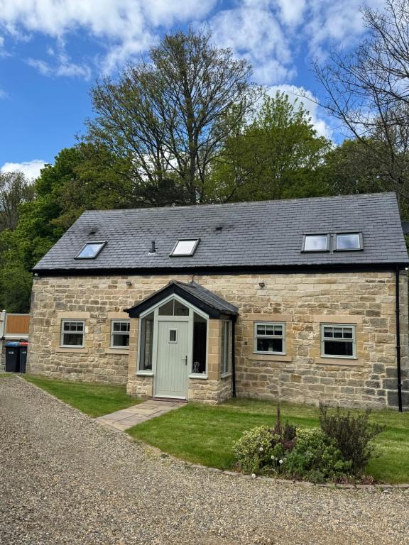 a stone house with a grey roof at Shepherds Barn in Beamish