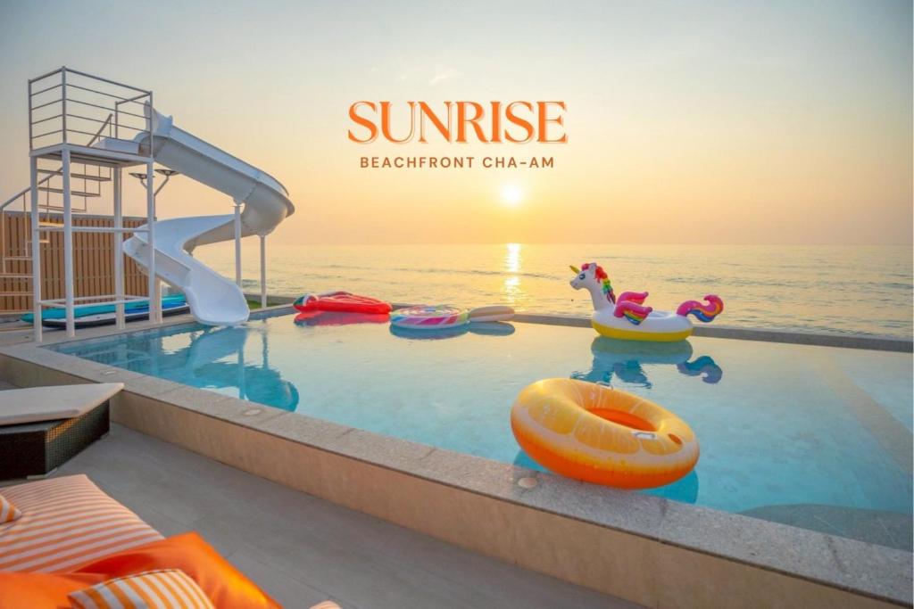 a swimming pool with a slide at SunRise Beachfront Cha am in Ban Bang Ket