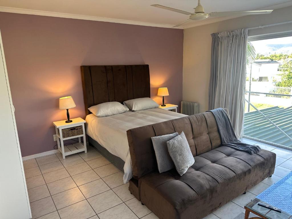 a bedroom with a bed and a couch at Loft Style Apartment in Monte Vista