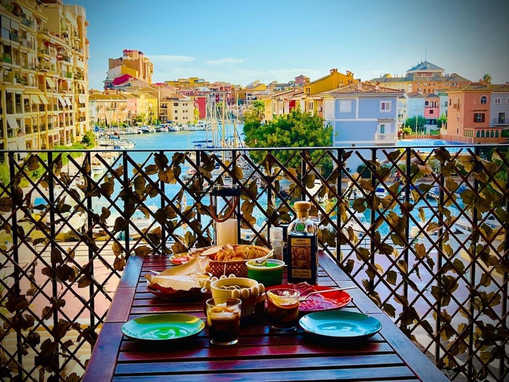 a table with food and drinks on a balcony at Premium Oceanside Apartment, Pool, Parking in Port Saplaya