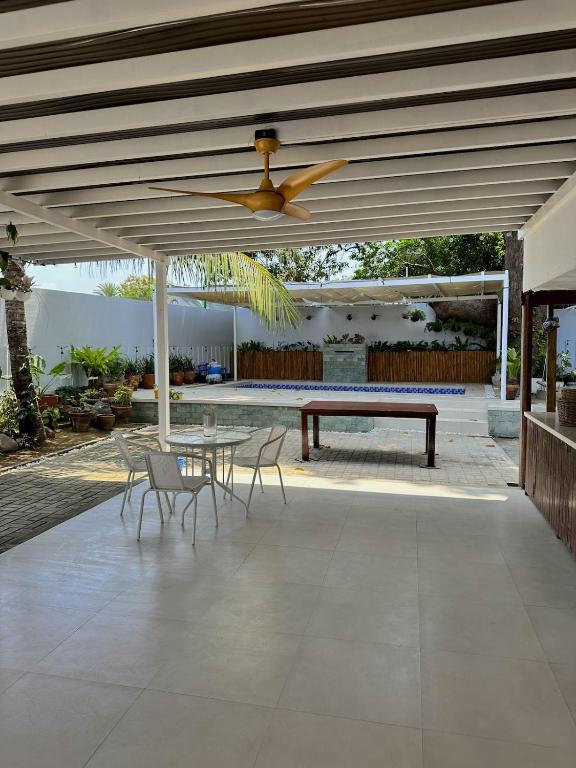 a patio with a table and a ceiling fan at Evergreen Private Pool Villa - Cavite in General Trias
