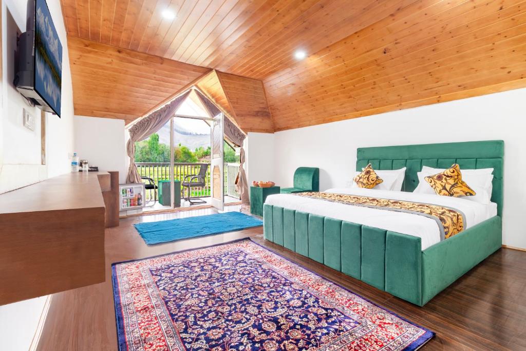 a bedroom with a king sized bed and a television at Royal Cliff Resort Pahalgam in Pahalgām
