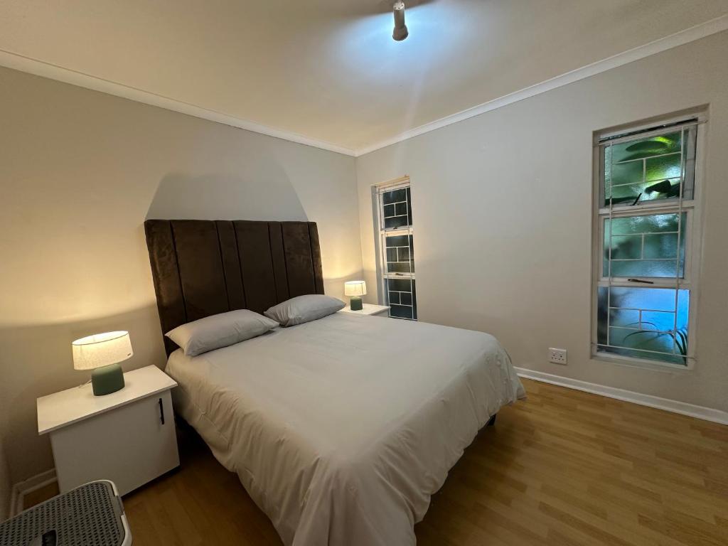 a bedroom with a large bed and two windows at Gorgeous Holiday Home in Monte Vista