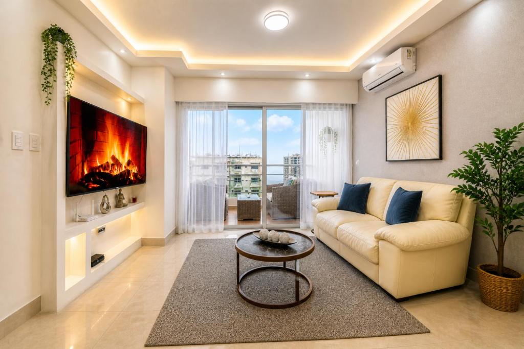a living room with a couch and a fireplace at Comfy City Center 1BR Condo in Los Prados