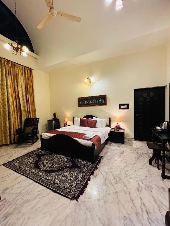 a large bedroom with a bed and a rug at The Regalis Villa in Lucknow